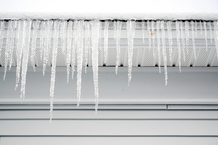 icicle hanging on house roofの写真素材