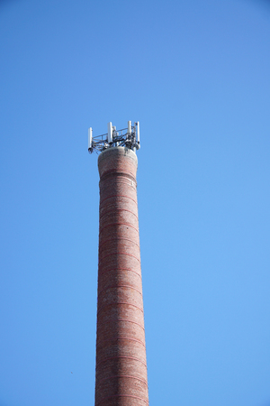 communication antenna installed on top of the brick chimneyの写真素材