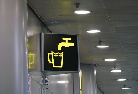 Information sign of drinking tap water and cup in airportの写真素材