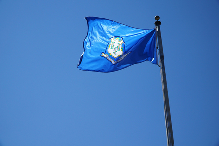 Connecticut flag waving on the pole in the windの写真素材