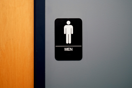 restroom sign outside restroom on the wallの写真素材