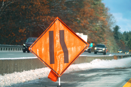 Road merge sign in the street in construction zone
