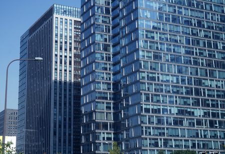 close up on modern office building skyscraper with blue glass wallの写真素材