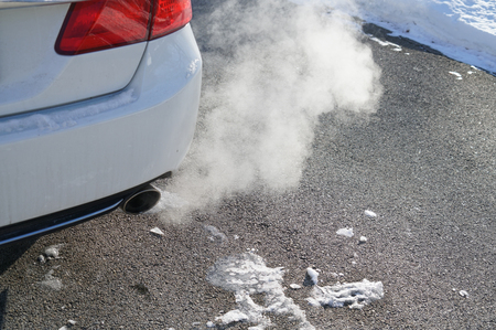 Close up on smoke from car pipe exhaust in winter seasonの写真素材