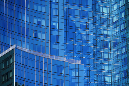 close up on modern office building skyscraper with blue glass wall
