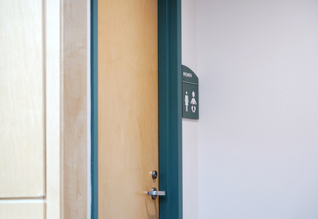 restroom sign outside restroom on the wallの写真素材