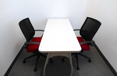 table and two chairs inside the meeting room
