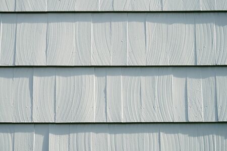 new painted gray cedar tile panel on the exterior wall