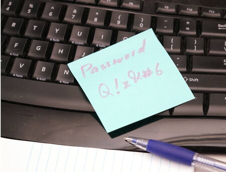 note pad with complicated password put on keyboardの写真素材
