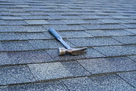 close up on hammer on the roof shingleの写真素材