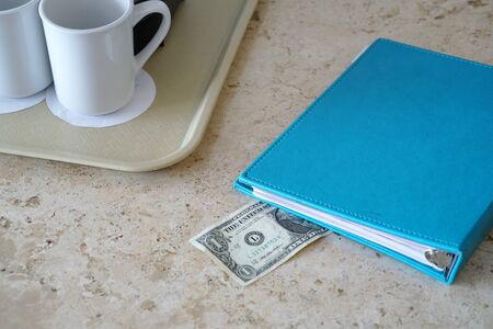 close up on tips left on the hotel room table