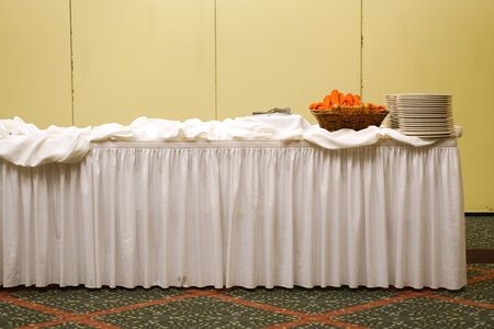 banquet table with table cloth and stacking plates