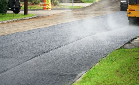 road pavement in residential area with steam