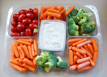 top view of fresh vegetable salad and sauce in plastic trayの写真素材