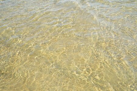 beach water surface with ripple in sand beachの写真素材