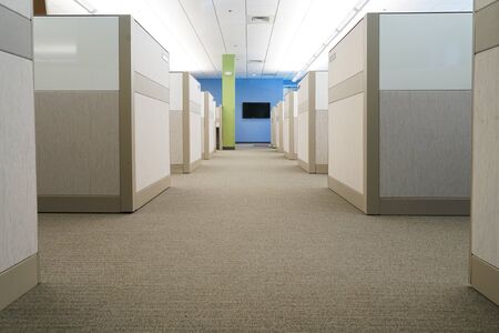 aisle between cubicles inside office buildingの写真素材