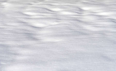 snow drift covered ground texture with shadowsの写真素材