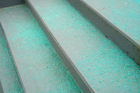 Melting salt on the stair steps in winter season