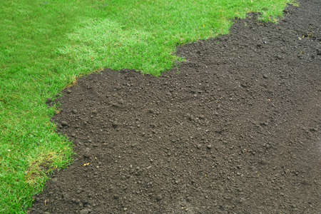 green lawn and dirt for new lawnの写真素材