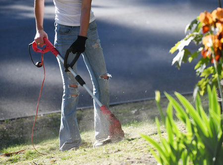 woman gardener working on trim the lawn