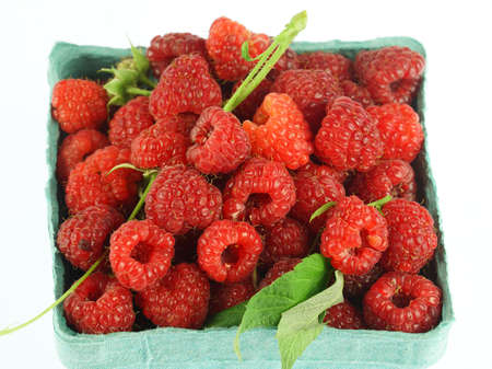 close up on fresh picked raspberry in container