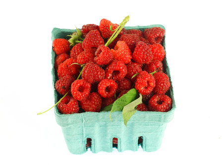 close up on fresh picked raspberry in container