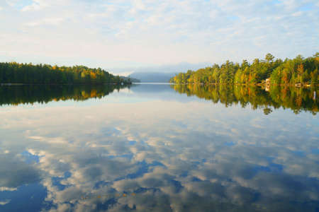 landscape of morning lake with autumn forest