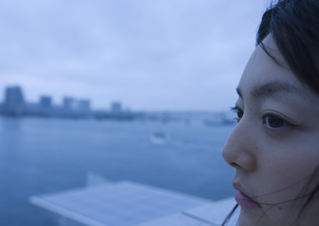 Young woman looking away on shipの写真素材