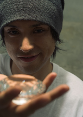 Man holding glass paper weight