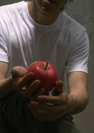 Man holding appleの写真素材