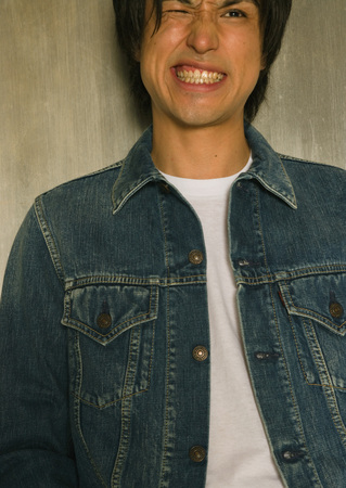 Young man grimacingの写真素材