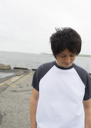 Man looking down on pierの写真素材