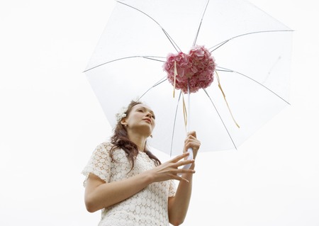 Young woman open an umbrellaの写真素材