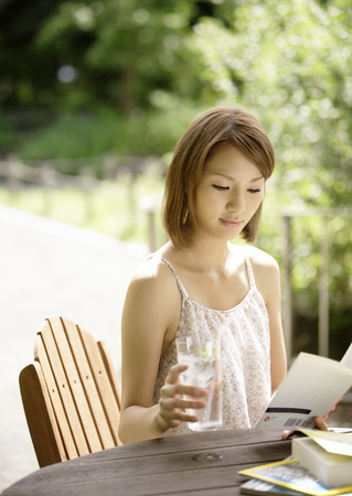 A young woman reading a bookの写真素材