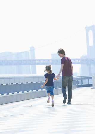Father and daughter taking a walkの写真素材