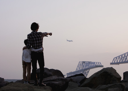 Father and son looking at airplaneの写真素材