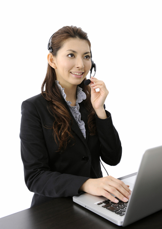 Businesswoman talking on headsetの写真素材