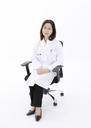 Female doctor sitting on chairの写真素材