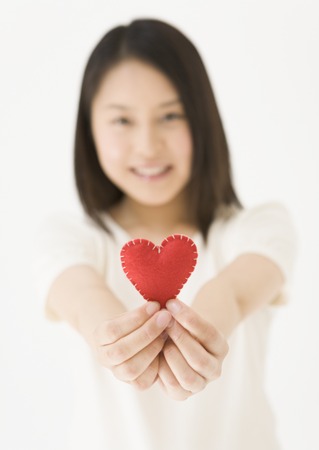 Woman Holding Heart Shaped Objectの写真素材