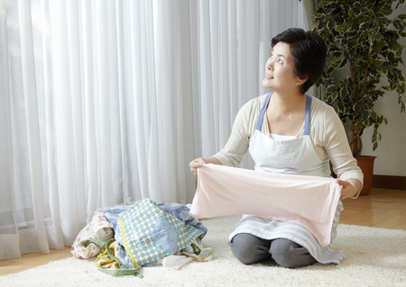 Woman folding laundryの写真素材