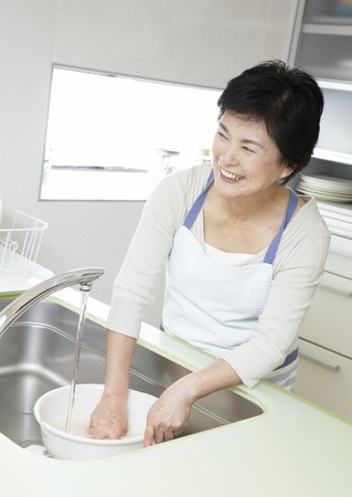 Woman washing riceの写真素材