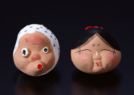 Earthenware bell of  distorted male and homely womanの写真素材