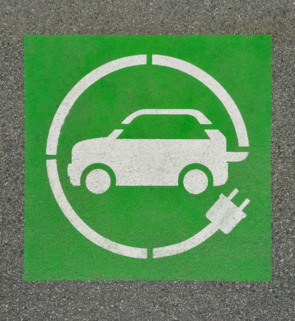 EV - electric vehicle charging station sign on asphalt. 'E' sign on asphalt textureの写真素材