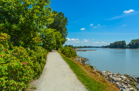 Walk way on river side close to the water. Fraser river side path in Vancouver, British Columbia. Peace of mind viewの写真素材