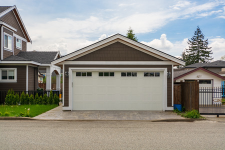 Detached garage of residential house with asphalt road in frontの写真素材