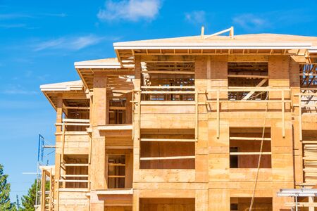 New apartment building under construction on sunny day on blue sky backgroundの写真素材