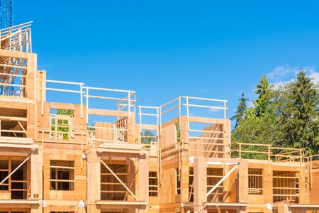 New condo building under construction on blue sky and trees backgroundの写真素材