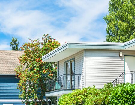 Upper level of residential house with the balcony on blue sky backgroundの写真素材