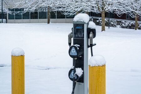 EV charging station for zero emission cars on white snow backgroundの写真素材