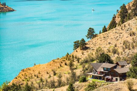 Great view on Kalamaka lake with luxury house and sailboat on the water